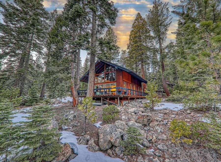 Nestled amidst towering trees, this charming cabin offers a serene escape.