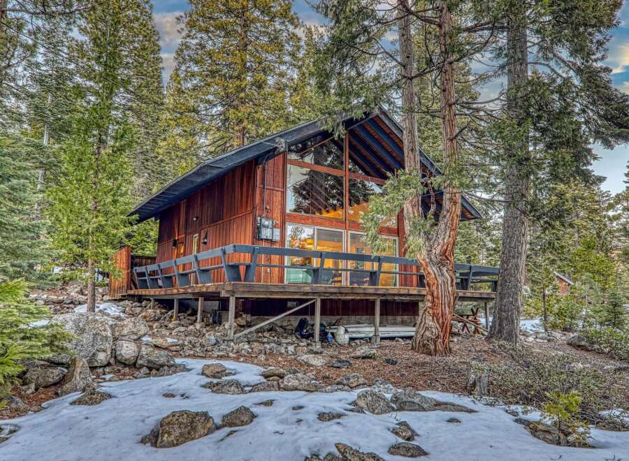Nestled in a serene forest setting, this stunning cabin offers a perfect blend of rustic charm and modern comfort.