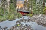 Nestled amidst towering trees and a serene landscape, this charming cabin offers a perfect blend of rustic charm and modern comfort.