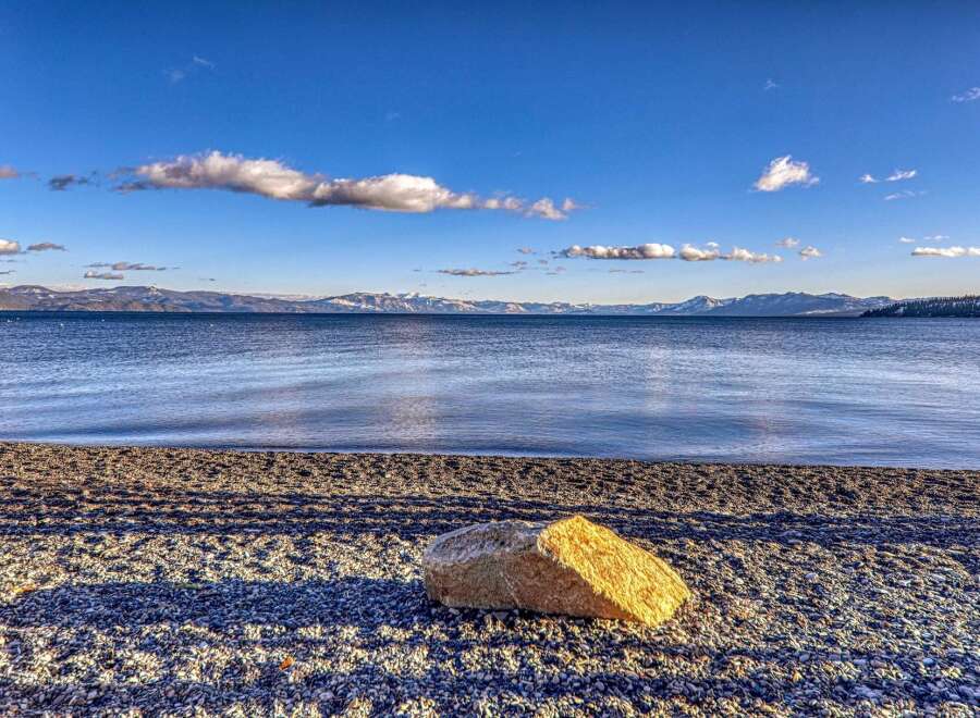 Enjoy breathtaking views of the lake and mountains from this stunning property.