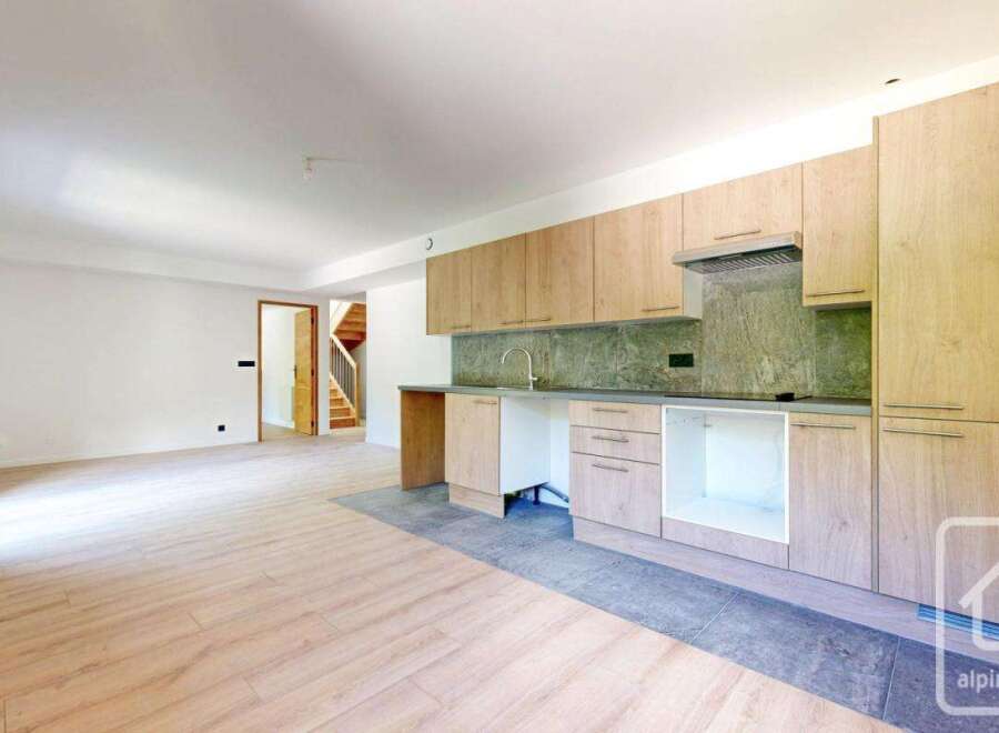 Discover this stunning property featuring a modern kitchen with sleek cabinetry and a stylish backsplash.