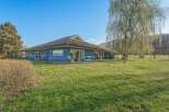 This stunning property boasts a beautiful blue exterior and a spacious, well-maintained lawn, perfect for outdoor activities.