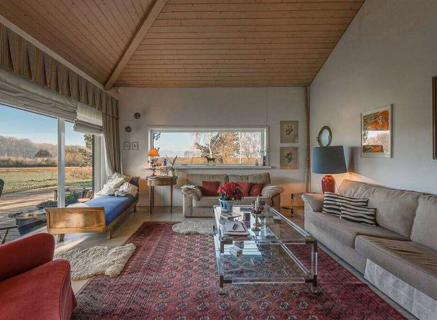 Experience the charm of this inviting living space, featuring a cozy seating area and a stunning view.