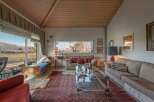 Experience the charm of this inviting living space, featuring a cozy seating area and a stunning view.