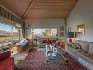 Experience the charm of this inviting living space, featuring a cozy seating area and a stunning view.