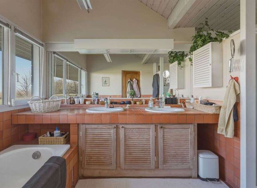 This spacious bathroom features a double vanity with ample counter space, perfect for getting ready in the morning.