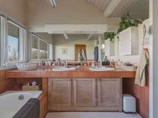 This spacious bathroom features a double vanity with ample counter space, perfect for getting ready in the morning.