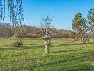 Discover the tranquility of this stunning property, featuring a unique stone lantern as a focal point.