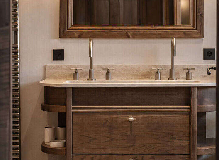 This stunning bathroom boasts a luxurious wooden vanity with ample storage and a sleek marble countertop.