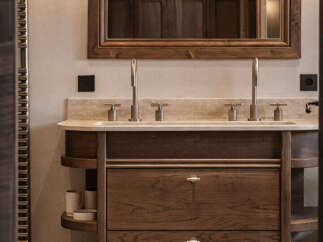 This stunning bathroom boasts a luxurious wooden vanity with ample storage and a sleek marble countertop.