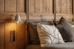 This cozy bedroom features a stunning wooden headboard, creating a warm and inviting atmosphere.