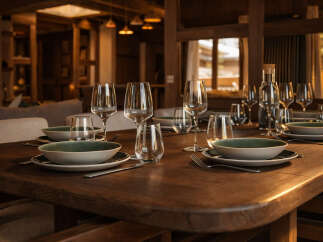Experience luxury living in this stunning property, featuring a beautifully set dining table perfect for hosting gatherings.