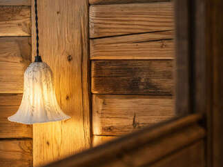 This stunning property features a rustic wooden wall, creating a warm and inviting atmosphere.
