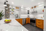 This stunning kitchen boasts a modern design with a touch of warmth.
