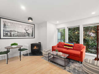 This cozy living space features a vibrant red sofa, perfect for relaxing.