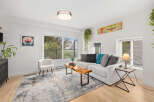 This stunning living room boasts a modern design with a comfortable white sofa, perfect for relaxing.