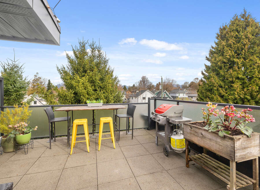 Enjoy outdoor living at its finest on this stunning balcony! This space features a stylish table and chairs, perfect for dining or relaxing.