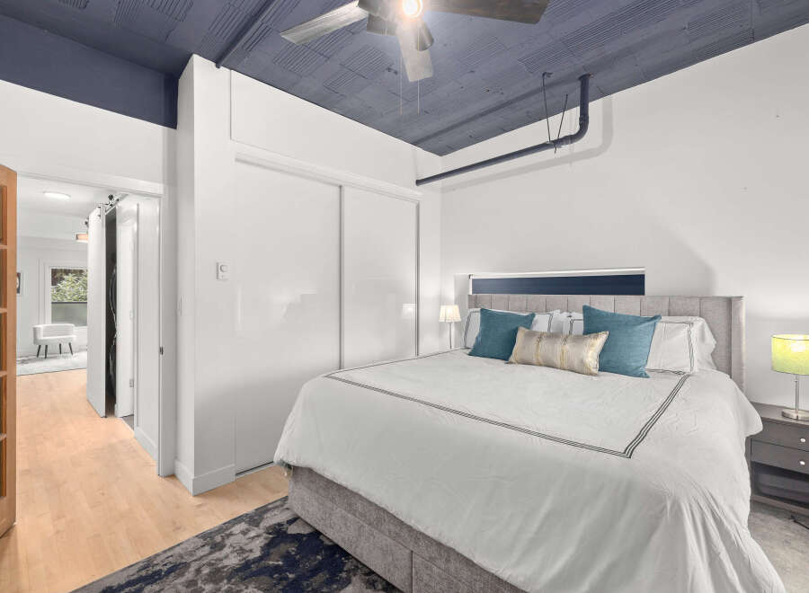 Step into this stylish bedroom featuring a modern design and a touch of elegance.