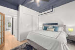 Step into this stylish bedroom featuring a modern design and a touch of elegance.