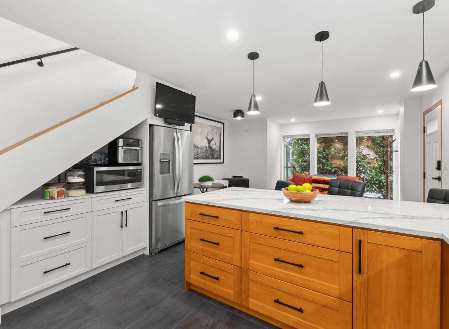 This stunning kitchen boasts a modern design with sleek stainless steel appliances and a spacious island.