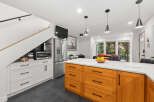 This stunning kitchen boasts a modern design with sleek stainless steel appliances and a spacious island.