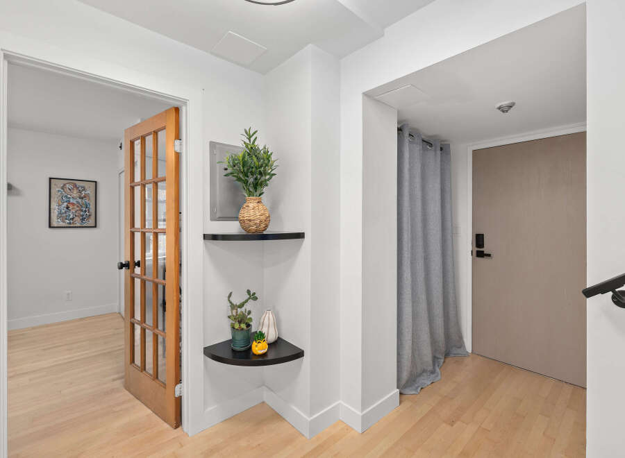 Step into this inviting entryway, showcasing a blend of modern design and natural elements.