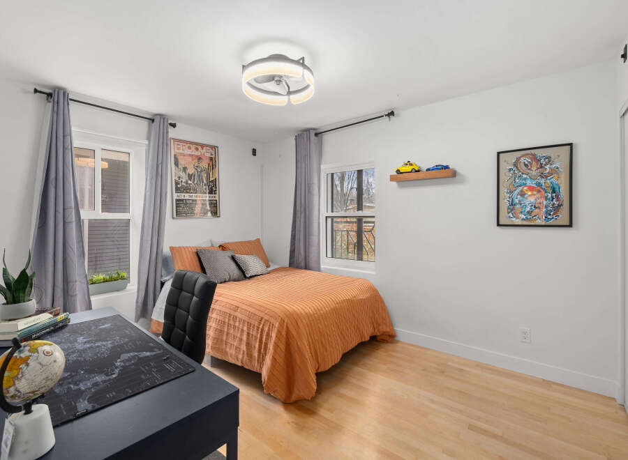 This cozy bedroom features a comfortable bed with stylish bedding, perfect for relaxation.