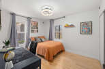 This cozy bedroom features a comfortable bed with stylish bedding, perfect for relaxation.