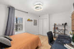 This cozy bedroom offers a comfortable retreat with its inviting ambiance and stylish decor.