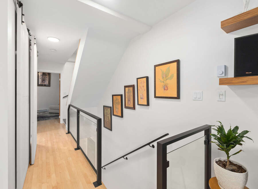 This stunning property features a bright and airy hallway with beautiful hardwood floors.