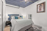 This stunning bedroom boasts a unique design with a striking blue ceiling and a cozy, inviting atmosphere.