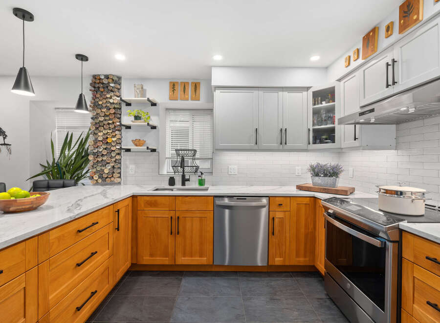 This stunning kitchen boasts a modern design with a touch of warmth, featuring beautiful wooden cabinetry and sleek stainless steel appliances.