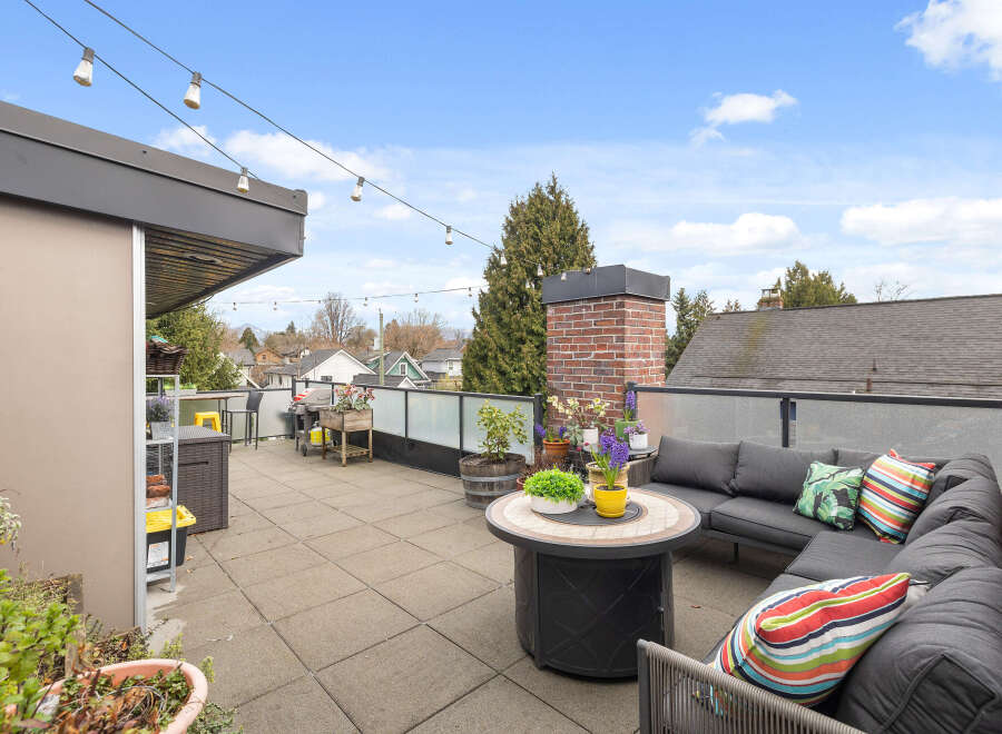 Enjoy outdoor living at its finest on this stunning rooftop patio! This space features a comfortable sectional sofa, perfect for relaxing and entertaining.