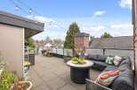 Enjoy outdoor living at its finest on this stunning rooftop patio! This space features a comfortable sectional sofa, perfect for relaxing and entertaining.
