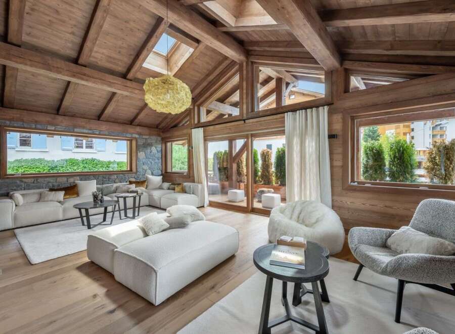 Experience luxury living in this stunning property featuring a spacious living area with a cozy fireplace and large windows.