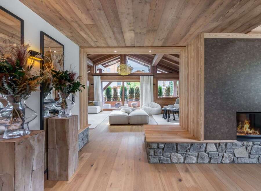 Step into luxury with this stunning property, showcasing exquisite wooden architecture and a cozy fireplace.