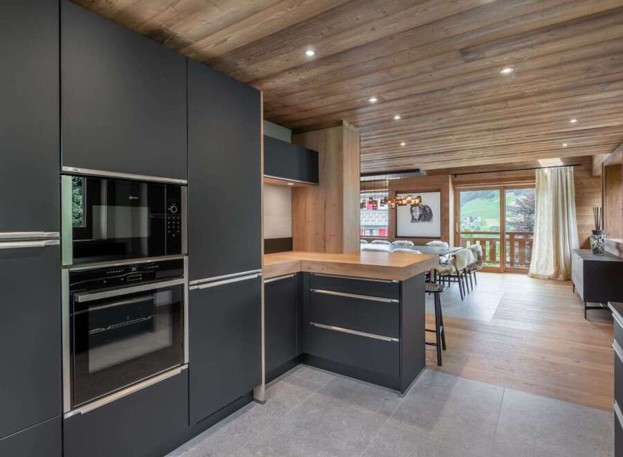 This stunning kitchen boasts modern appliances and sleek cabinetry, perfect for culinary enthusiasts.