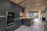 This stunning kitchen boasts modern appliances and sleek cabinetry, perfect for culinary enthusiasts.
