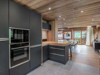 This stunning kitchen boasts modern appliances and sleek cabinetry, perfect for culinary enthusiasts.