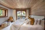 Experience luxury in this stunning bedroom featuring a cozy ambiance.