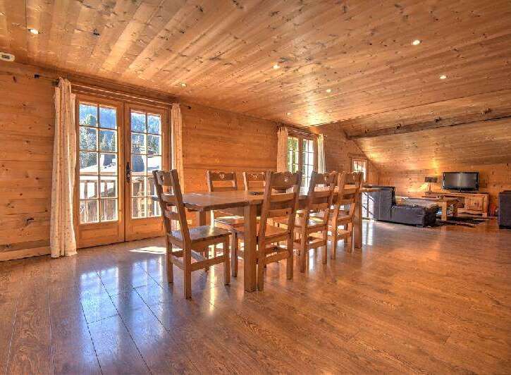 This stunning property boasts a warm and inviting interior with beautiful wooden accents throughout.