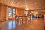 This stunning property boasts a warm and inviting interior with beautiful wooden accents throughout.