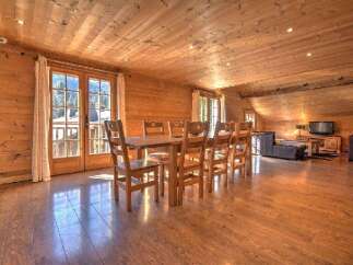 This stunning property boasts a warm and inviting interior with beautiful wooden accents throughout.