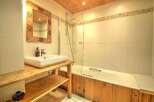 Discover the charm of this bathroom, featuring a rustic wooden vanity and a sleek, modern sink.