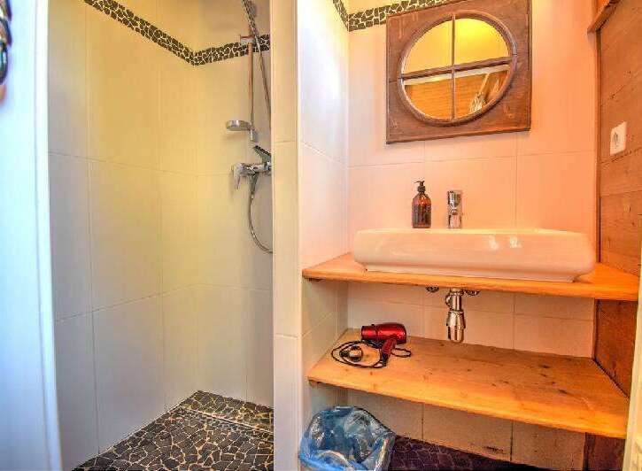 Discover this charming bathroom featuring a modern shower and a stylish sink area.