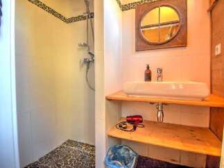 Discover this charming bathroom featuring a modern shower and a stylish sink area.