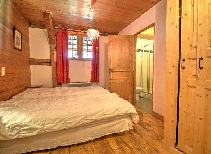 This charming bedroom features a cozy wooden interior, creating a warm and inviting atmosphere.