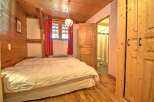 This charming bedroom features a cozy wooden interior, creating a warm and inviting atmosphere.