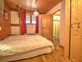 This charming bedroom features a cozy wooden interior, creating a warm and inviting atmosphere.