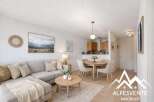 Discover this charming property featuring a cozy living area with a comfortable sectional sofa and a stylish round coffee table.
